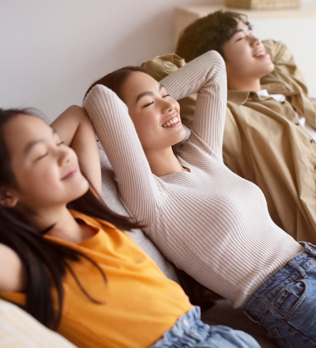 Smiling millennial asian couple and teen daughter